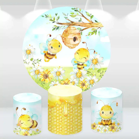 Adorable bee and daisy party decor set including a round backdrop and cylinder covers with honeycomb and bee designs, ideal for baby showers and birthdays
