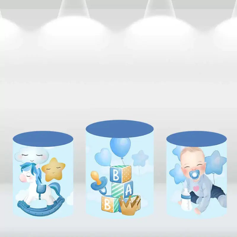 Set of three cylindrical pedestal covers with designs featuring rocking horses, toys, and stars in blue, perfect for baby boy-themed event décor.