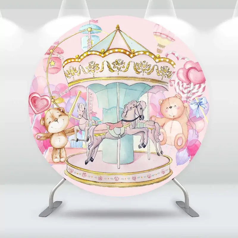 Round baby shower backdrop with a carousel, teddy bear, and pastel balloon decorations
