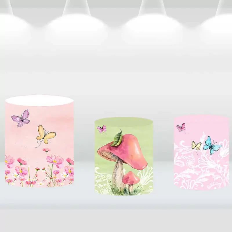 Garden-themed cylinder covers with pink and green floral and mushroom motifs, perfect for a fairy party.