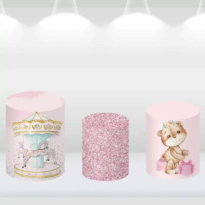 Decorative cylinder covers with pastel carousel and teddy bear themes for a baby shower.