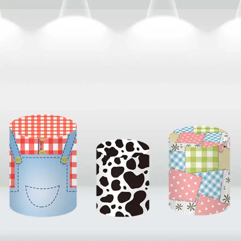 Set of cylinder covers with farm-themed designs, including a cow print, patchwork, and overalls.