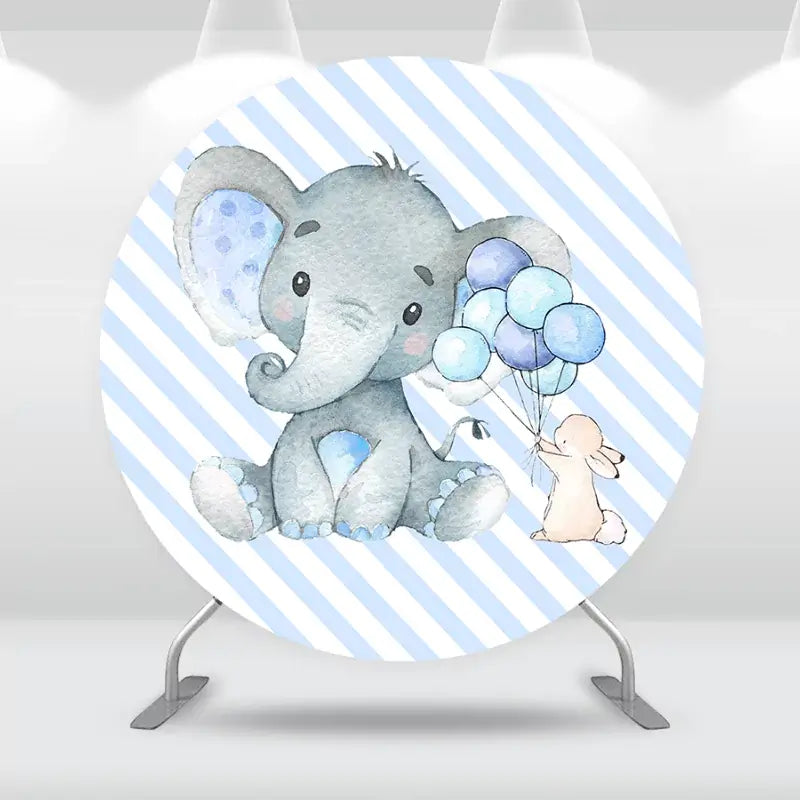 Round party backdrop featuring a baby elephant holding blue balloons with a bunny on a striped background.