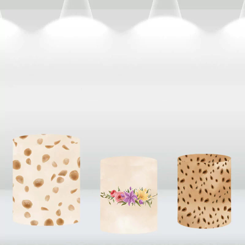 Set of three safari-themed cylinder covers featuring patterns inspired by jungle animals and floral designs, matching the safari animal backdrop