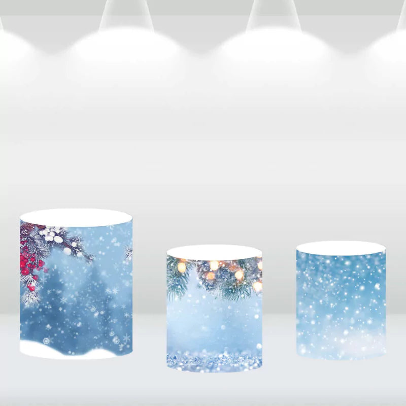Set of three cylindrical pedestal covers featuring winter designs, including snowflakes and Christmas decorations, complementing a Christmas-themed backdrop.