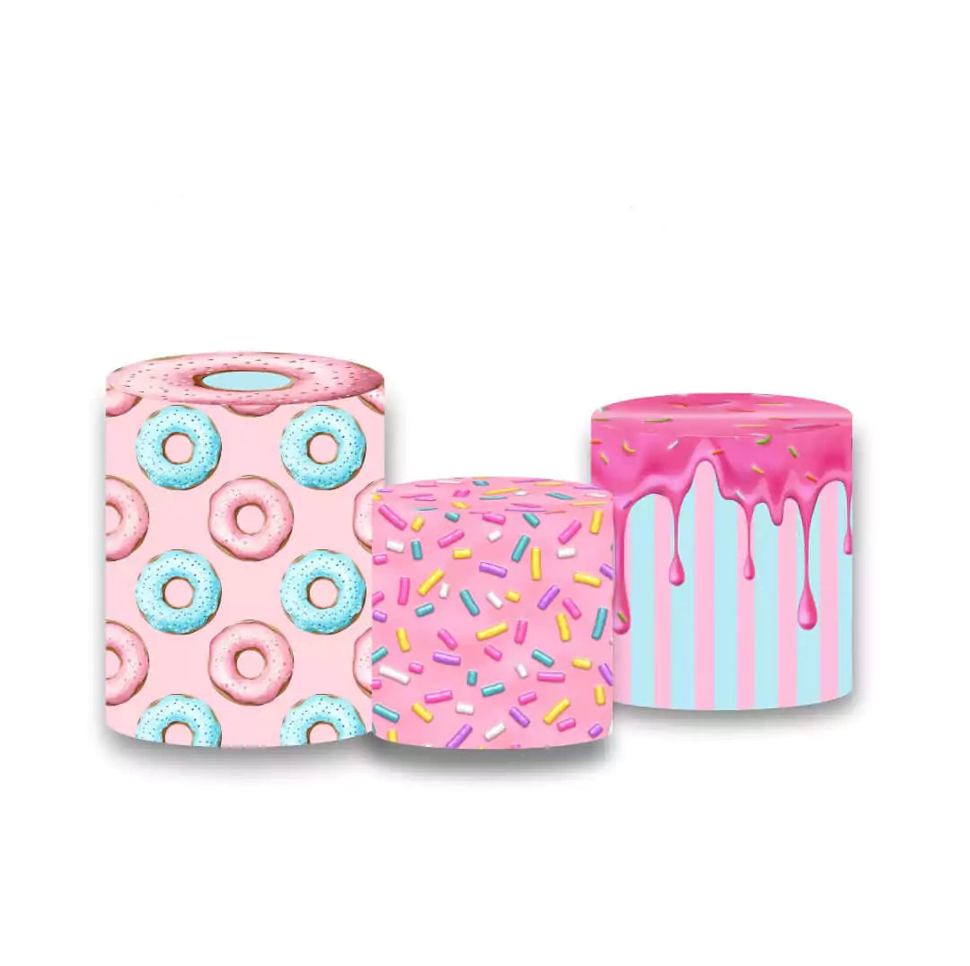 Set of three cylindrical pedestal covers featuring donut, sprinkle, and icing drip patterns, complementing a donut-themed backdrop.