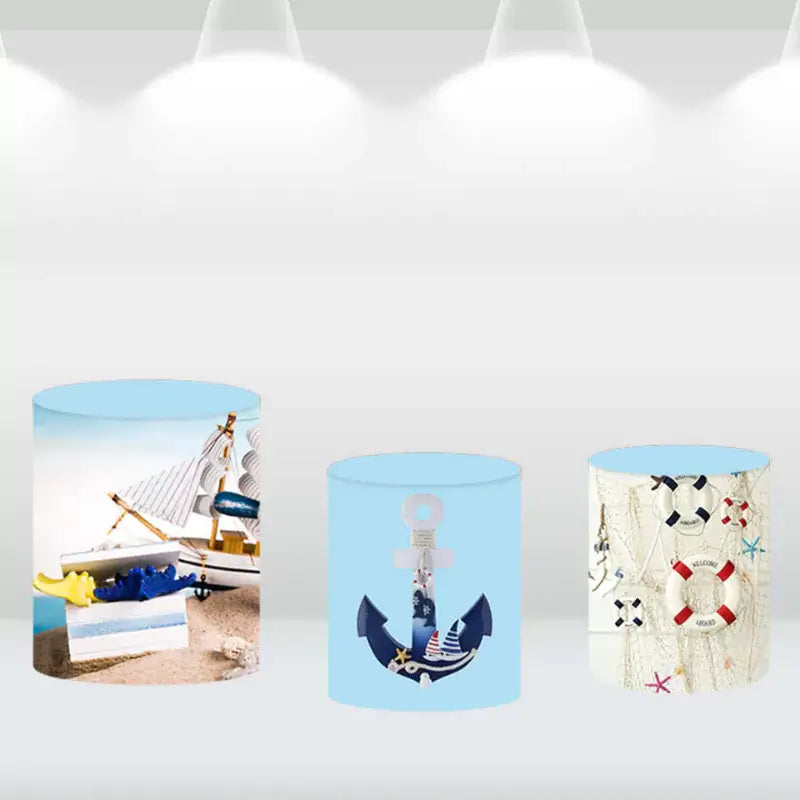 Set of three cylindrical pedestal covers featuring nautical designs with anchors, sailboats, and life preservers, perfect for beach-themed events.