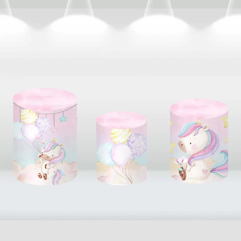 Set of three cylinder covers featuring unicorns, balloons, and pastel colors, matching the unicorn-themed party backdrop.