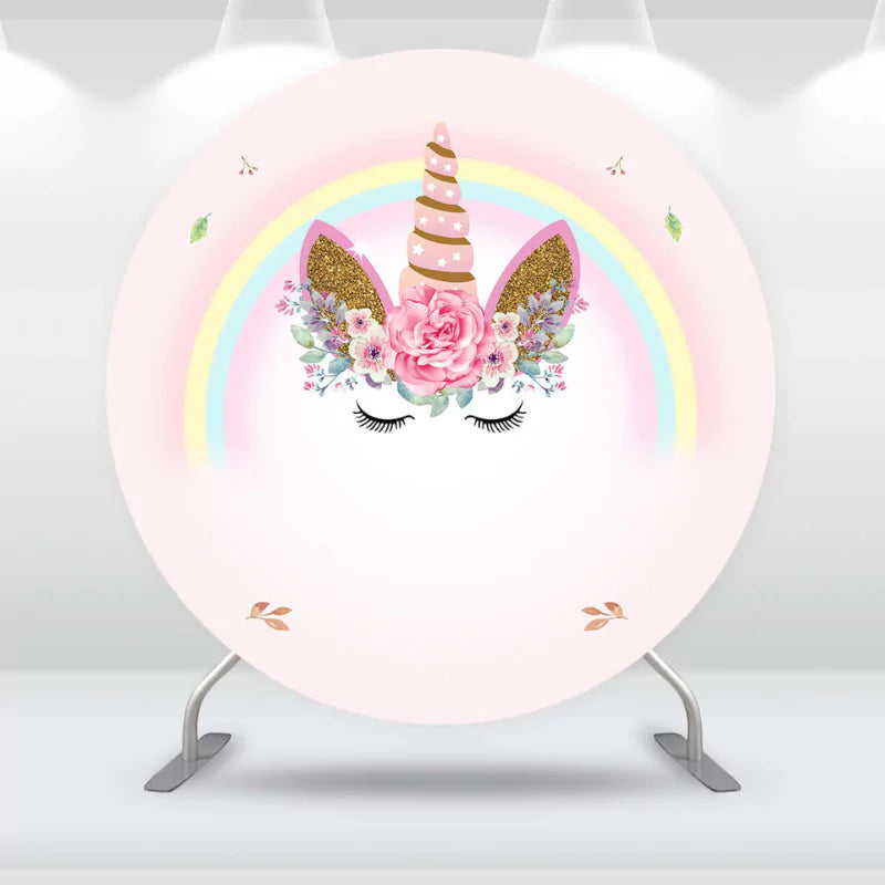 Round unicorn party backdrop featuring a unicorn horn, floral accents, and a pastel rainbow, perfect for children's birthdays.