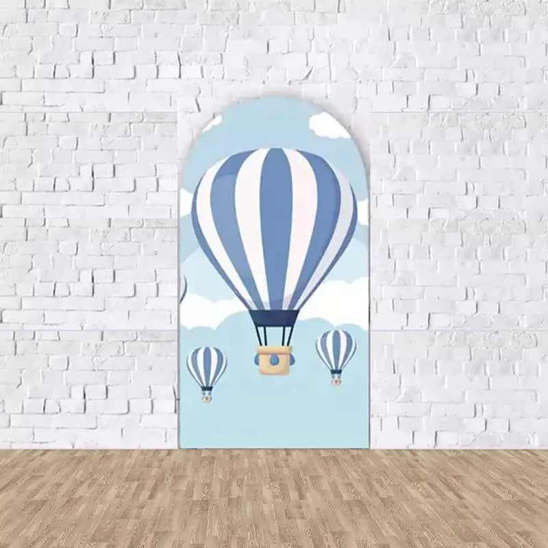 Center arched backdrop with a close-up of a blue and white hot air balloon floating in a clear sky, ideal for adventure-themed party decor.