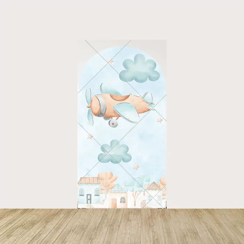 Arch panel with watercolor orange and blue airplane flying among fluffy clouds and stars—houses and trees line the bottom of the scene.