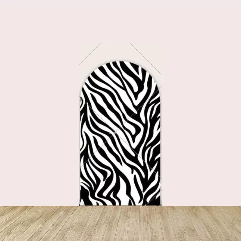 Black and white zebra pattern arched backdrop, great for safari or jungle-themed parties.