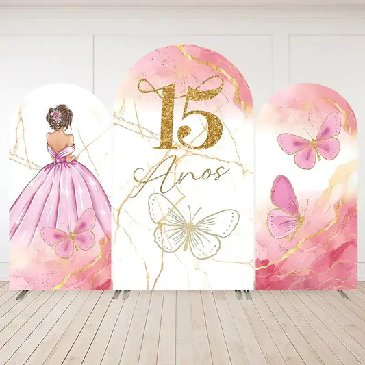 Pink arched backdrop with gold accents, butterflies, and a Quinceañera gown design featuring the text "15 Años."