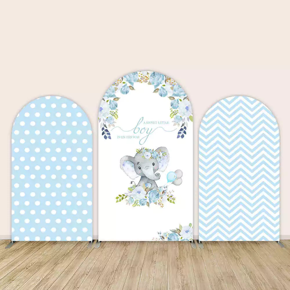 Three-panel baby shower arch backdrop for a boy with elephant illustration, blue floral design, polka dots, and chevron pattern.
