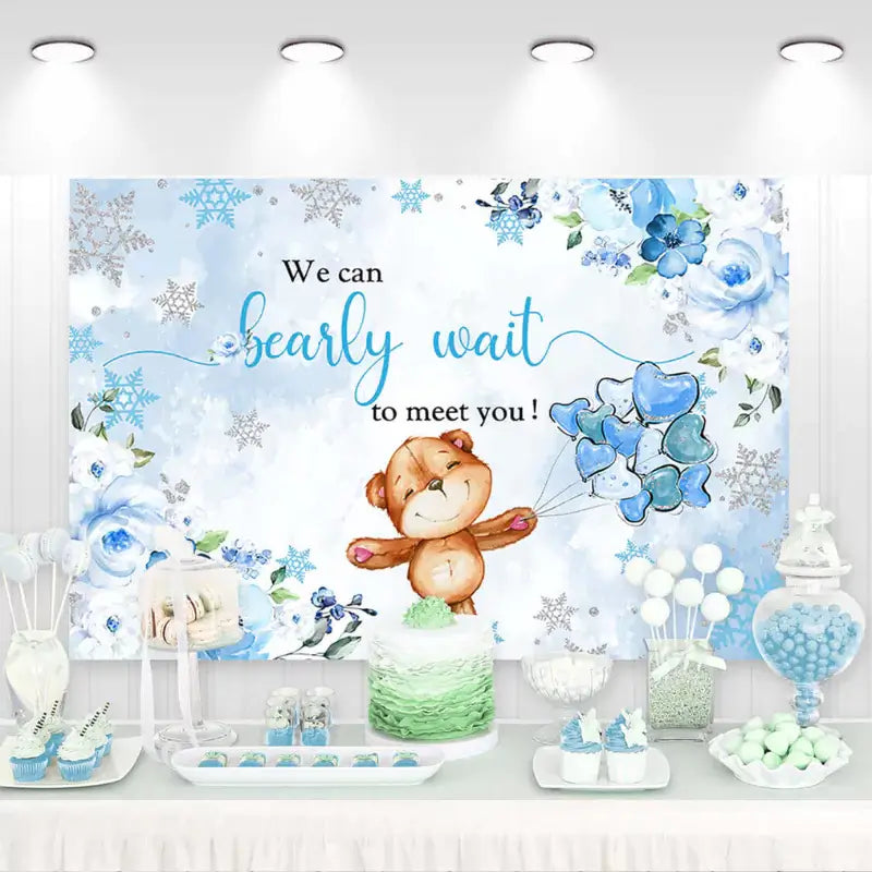Winter-themed baby shower backdrop with cute teddy bear holding blue balloons, snowflakes, and watercolor florals – 'We Can Bearly Wait to Meet You' message, perfect for baby boy celebrations