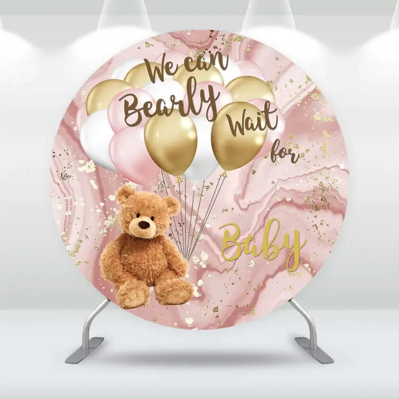 Round baby shower backdrop with plush teddy bear, pink and gold balloons, and marbled background – features ‘We Can Bearly Wait for Baby’ text in elegant script