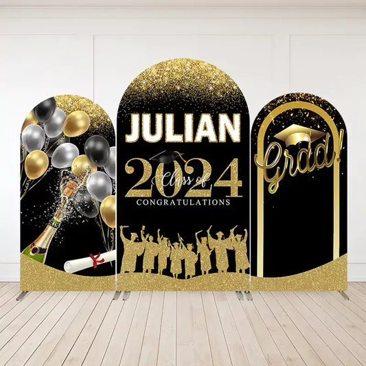 Three-panel graduation-themed arch backdrop set in black and gold with “Julian Class of 2024,” champagne bottle, balloons, and graduate silhouettes.