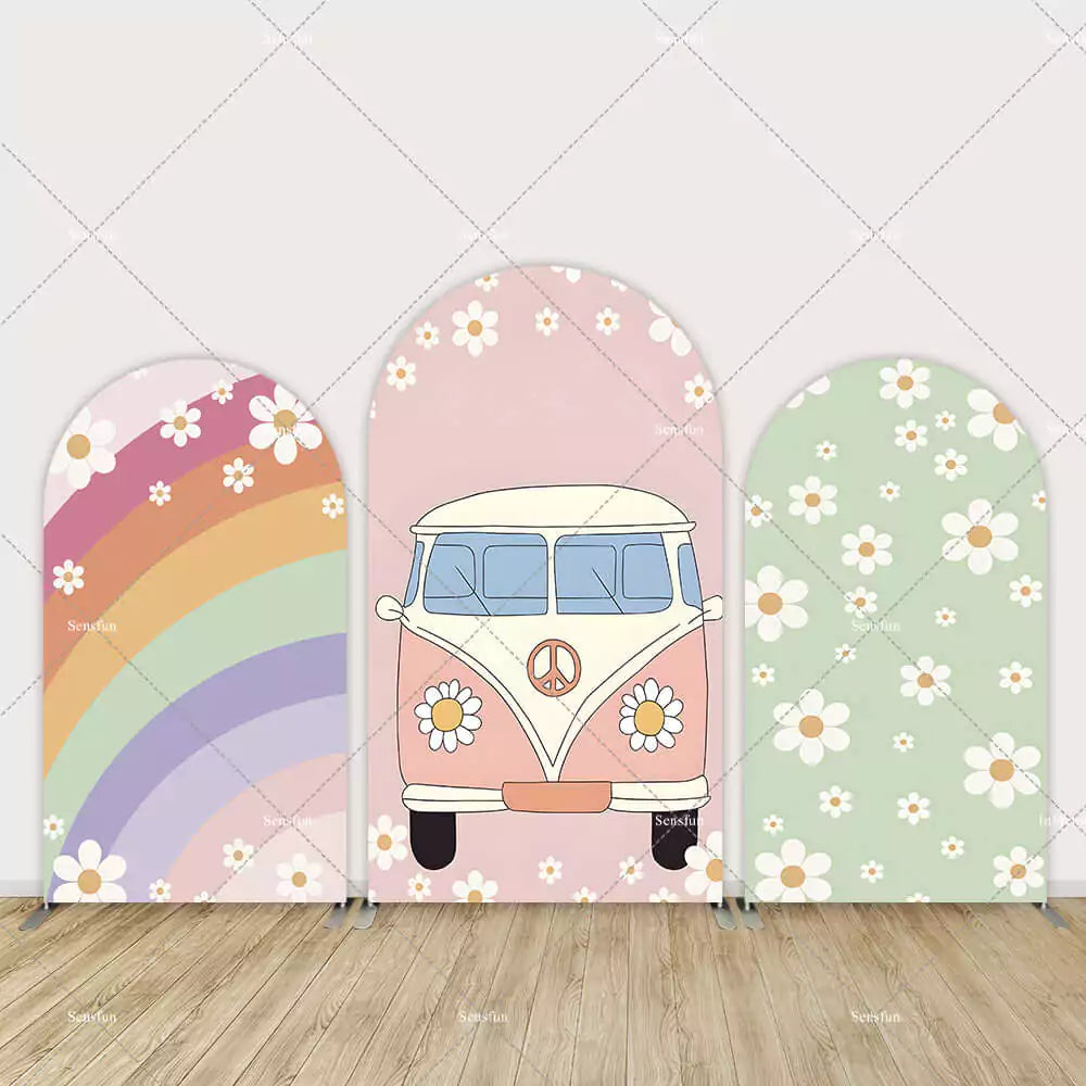 Three-piece boho arch backdrop featuring a rainbow with daisies, a peace sign flower van, and a green daisy pattern panel.