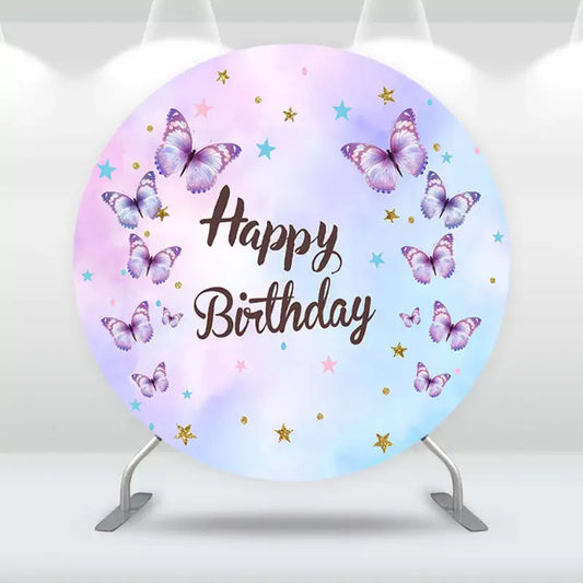 Whimsical butterfly-themed birthday party backdrop in pink, purple, and blue hues.