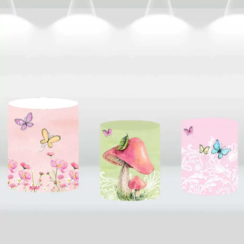 Three garden-themed backdrop cylinder covers featuring butterflies, flowers, and mushrooms