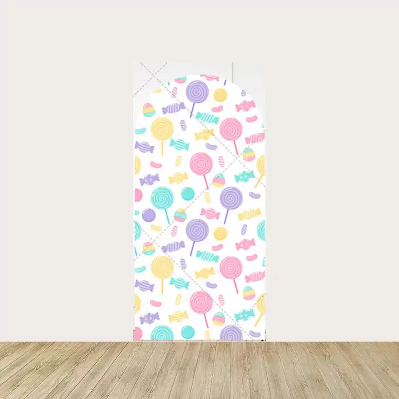 Center panel of a personalized candy-themed backdrop with the name "Elyana" in gold, surrounded by pastel candies and lollipops.