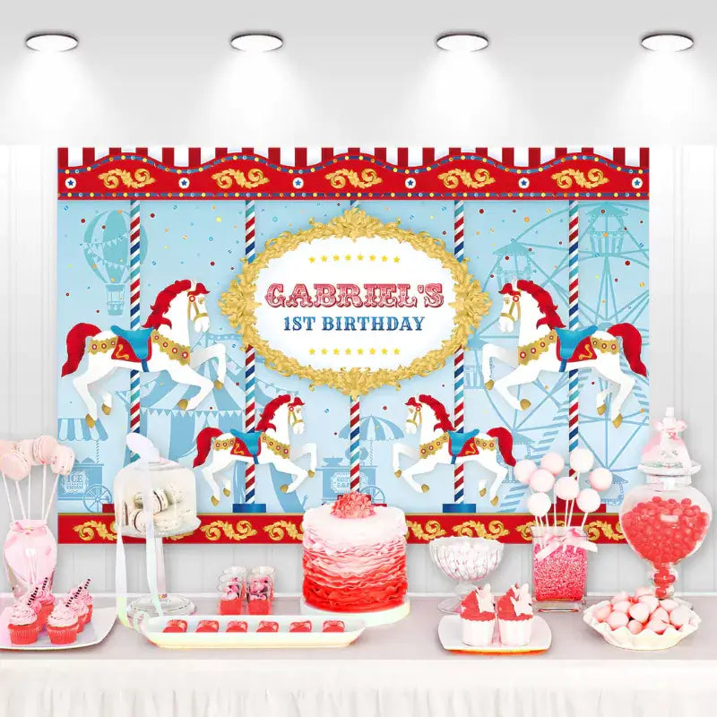 Carnival-themed first birthday backdrop with carousel horses, red and white stripes, gold accents, and personalized name for a whimsical celebration