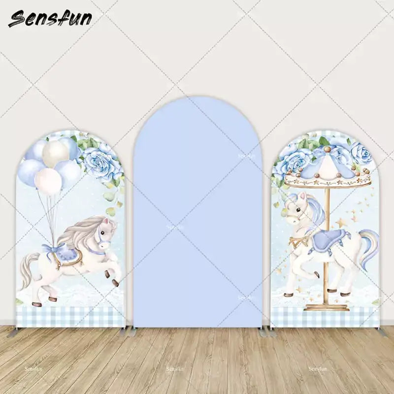 Three-panel blue arch backdrop set with carousel horse illustrations, balloons, blue roses, and gingham pattern—perfect for baby showers.