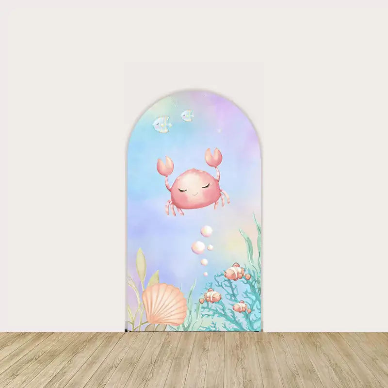 Right panel with smiling crab, seashells, and soft sea plants on a pastel blue-purple background—perfect for under-the-sea baby showers.