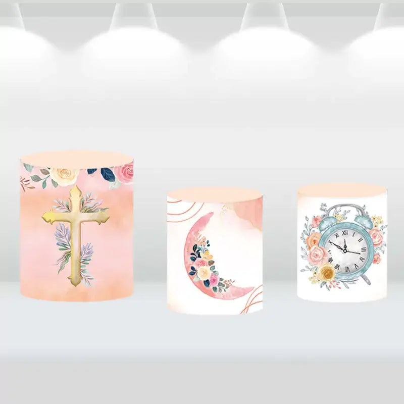Set of three cylindrical pedestal covers featuring floral designs with a cross, moon arrangement, and vintage clock, complementing a cross-themed backdrop.