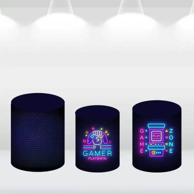 Set of three cylindrical pedestal covers featuring neon designs of gaming icons like arcade machines and video game controllers, perfect for complementing a gamer-themed event.