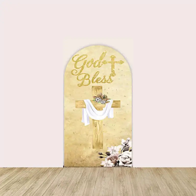 Right arch with golden cross draped in white cloth, floral base accents, and “God Bless” written in shimmering gold above.