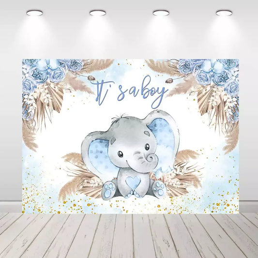 It’s a Boy baby shower backdrop with adorable gray elephant, blue ears and heart, surrounded by watercolor florals, palm leaves, and gold splatter – perfect for boy baby showers