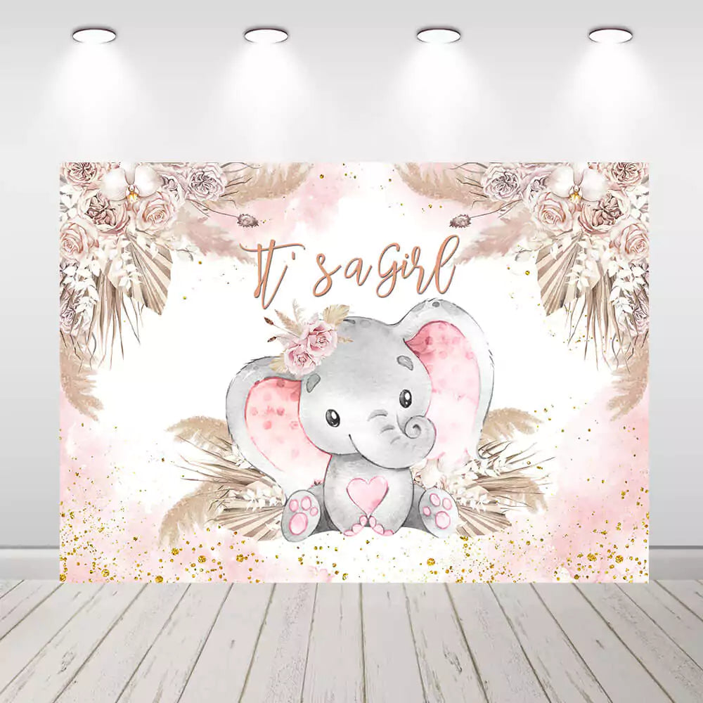 It’s a Girl baby shower backdrop with adorable baby elephant wearing a flower crown, surrounded by pink and beige floral arrangements and gold glitter accents