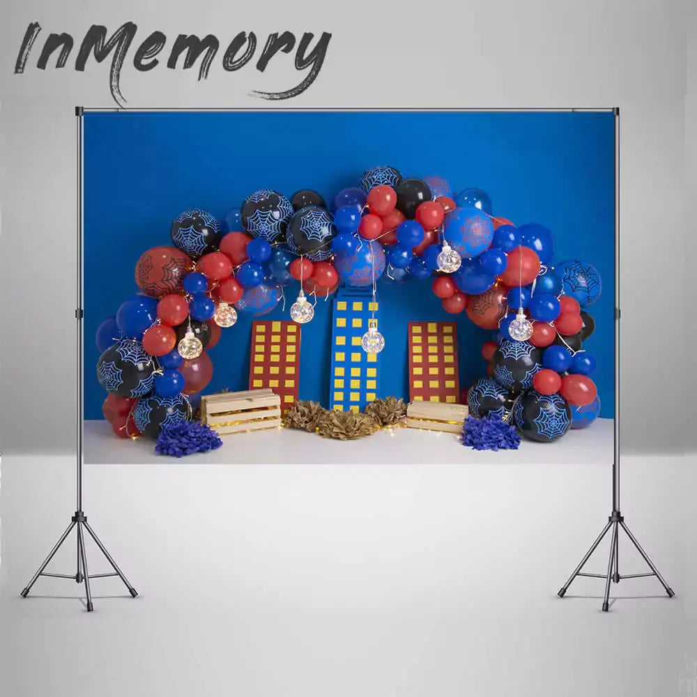 Superhero party backdrop featuring cityscape decorations and balloon arches, ideal for kids' birthday celebrations.