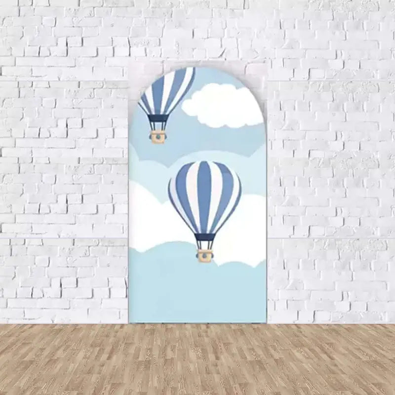 Right arched backdrop with hot air balloons floating in a sky filled with clouds, evoking a theme of travel and exploration.