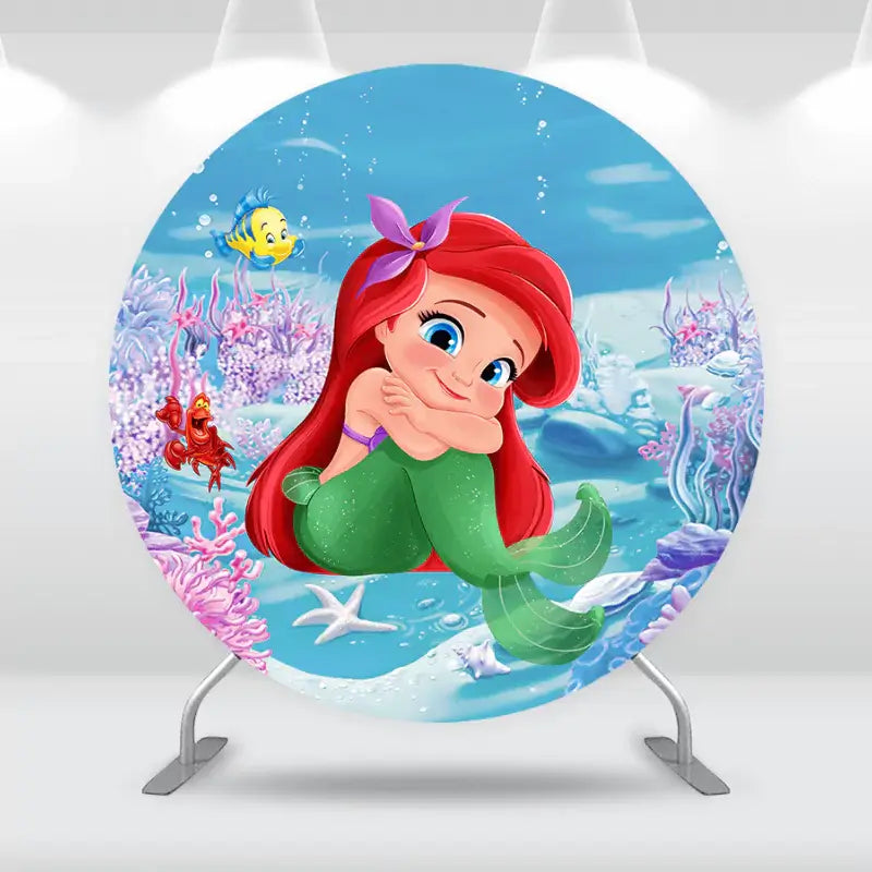Round mermaid birthday backdrop with red-haired mermaid, colorful coral reef, and underwater friends – perfect for ocean or Little Mermaid themed parties