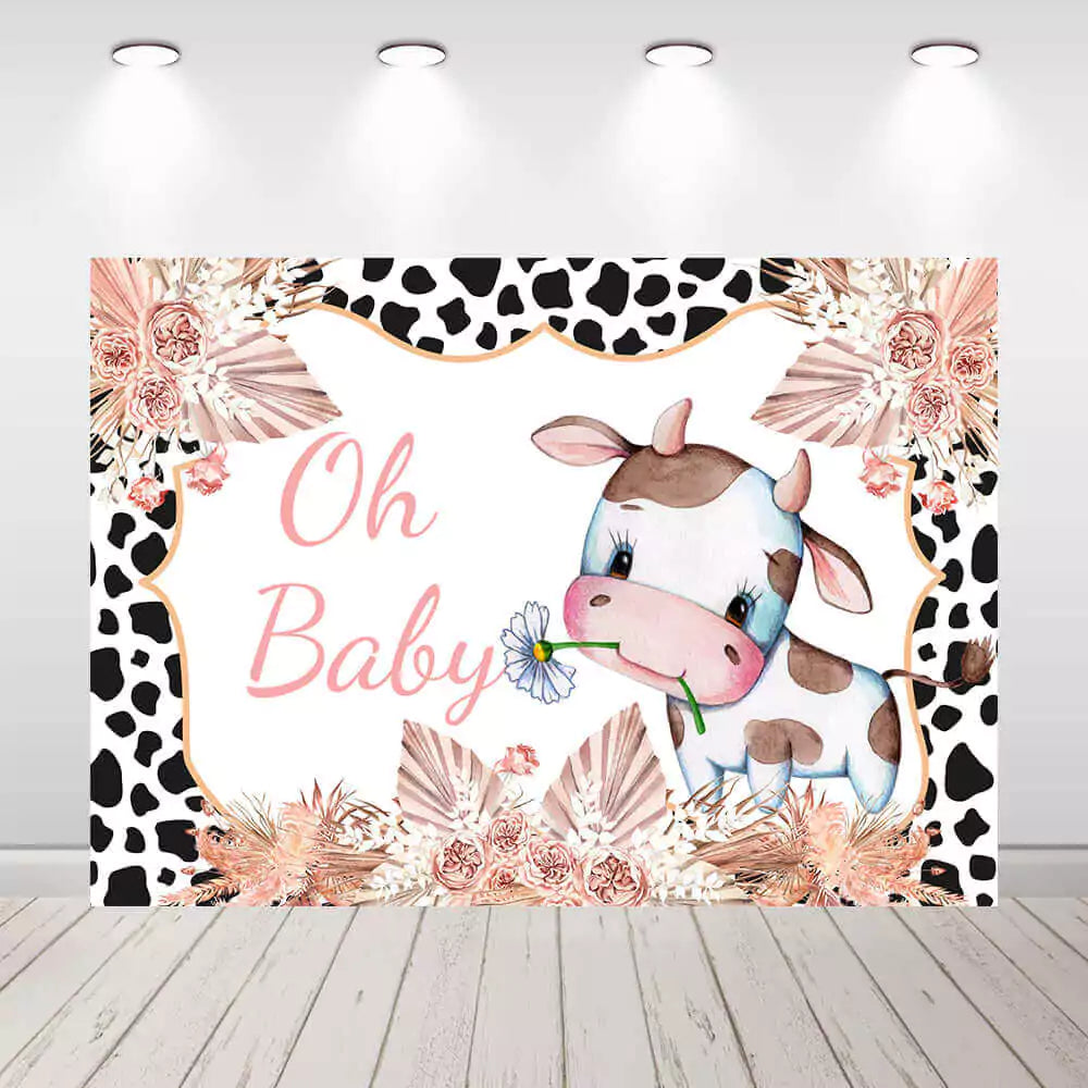 Oh Baby baby shower backdrop with cute cartoon cow holding a flower, surrounded by pink florals, cow print border, and soft boho pampas – perfect for a farm or western baby shower