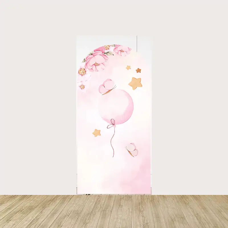 Arch panel with soft pink balloon, butterflies, golden stars, and floral garland—whimsical decor for baby girl parties or photo booths.