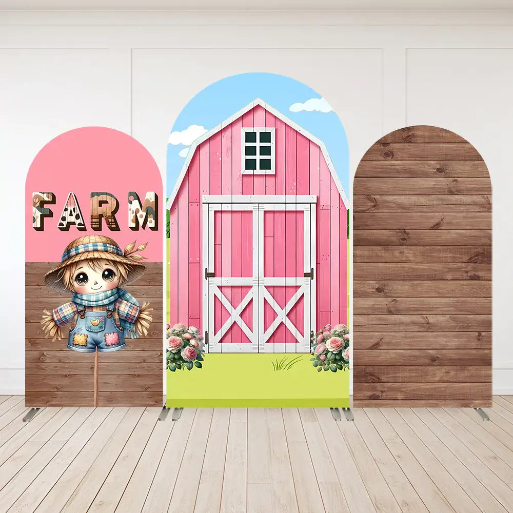 Arched backdrop featuring a bright pink barn with white doors, surrounded by flowers and a clear blue sky, ideal for farm-themed parties.