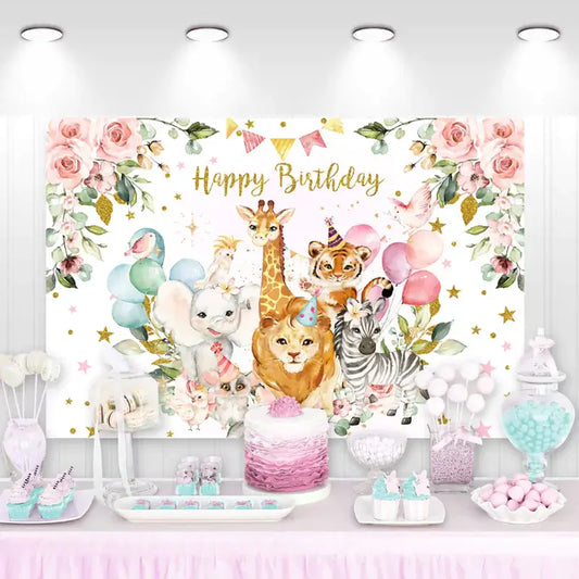 Pink safari birthday backdrop with watercolor jungle animals including elephant, giraffe, lion, zebra, and tiger wearing party hats – surrounded by balloons and floral decorations.