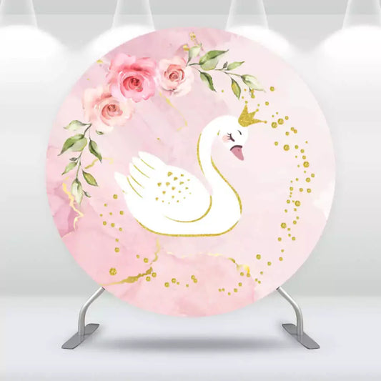Elegant round backdrop with a white swan wearing a gold crown, set against a soft pink watercolor background with floral accents and golden sparkles.