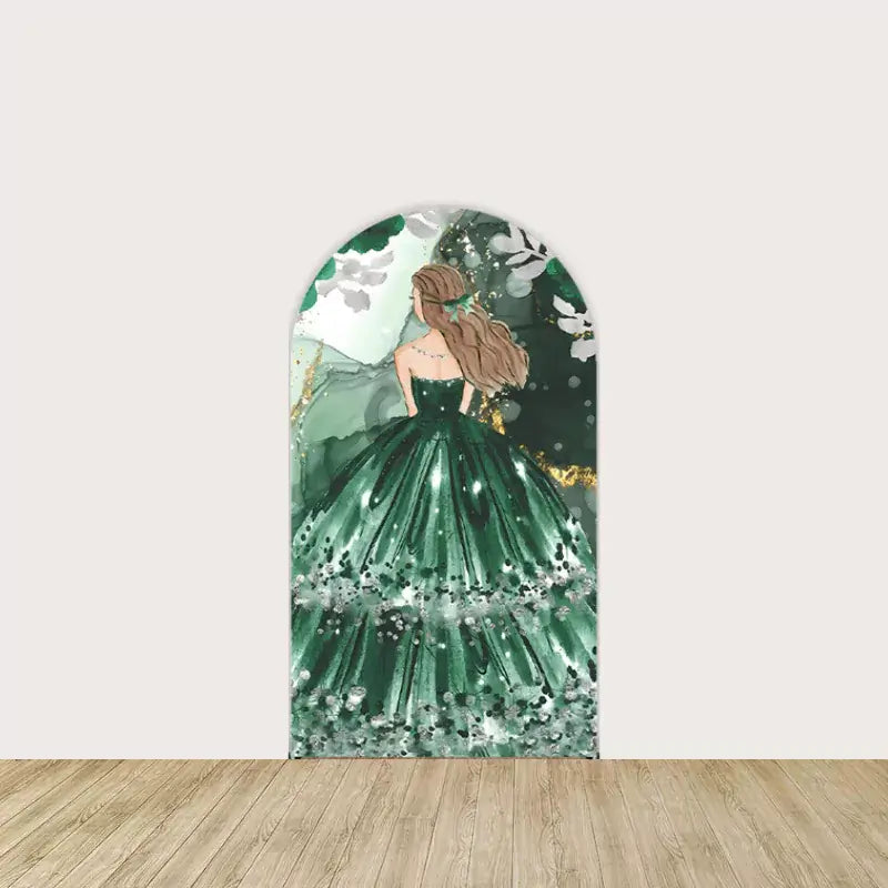Arch backdrop showing a girl in a sparkly emerald green gown with long hair and a dreamy background.