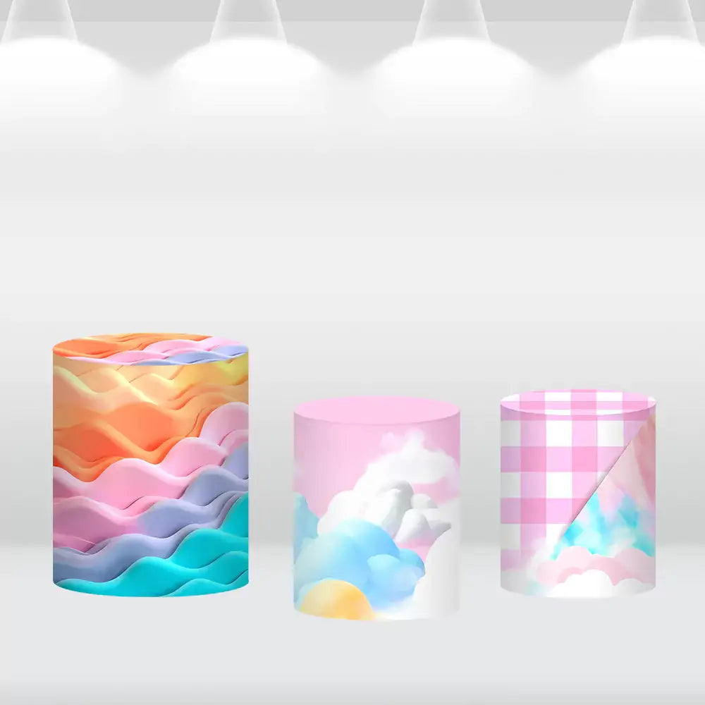 Set of three cylinder covers featuring a rainbow wave pattern, pastel clouds design, and pink gingham with fantasy-inspired details to complement the unicorn backdrop.