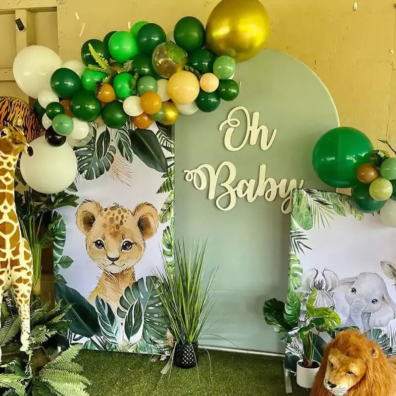 Backdrop featuring a baby lion surrounded by tropical leaves, adding an adorable jungle vibe to the baby shower setup.