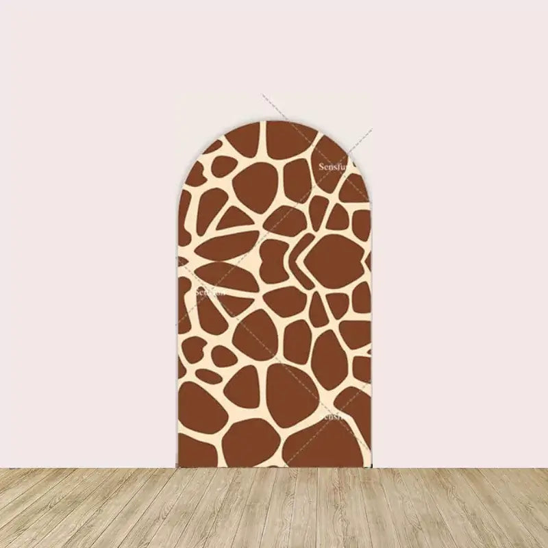 Brown and tan giraffe print arched backdrop, ideal for safari or animal-themed events.