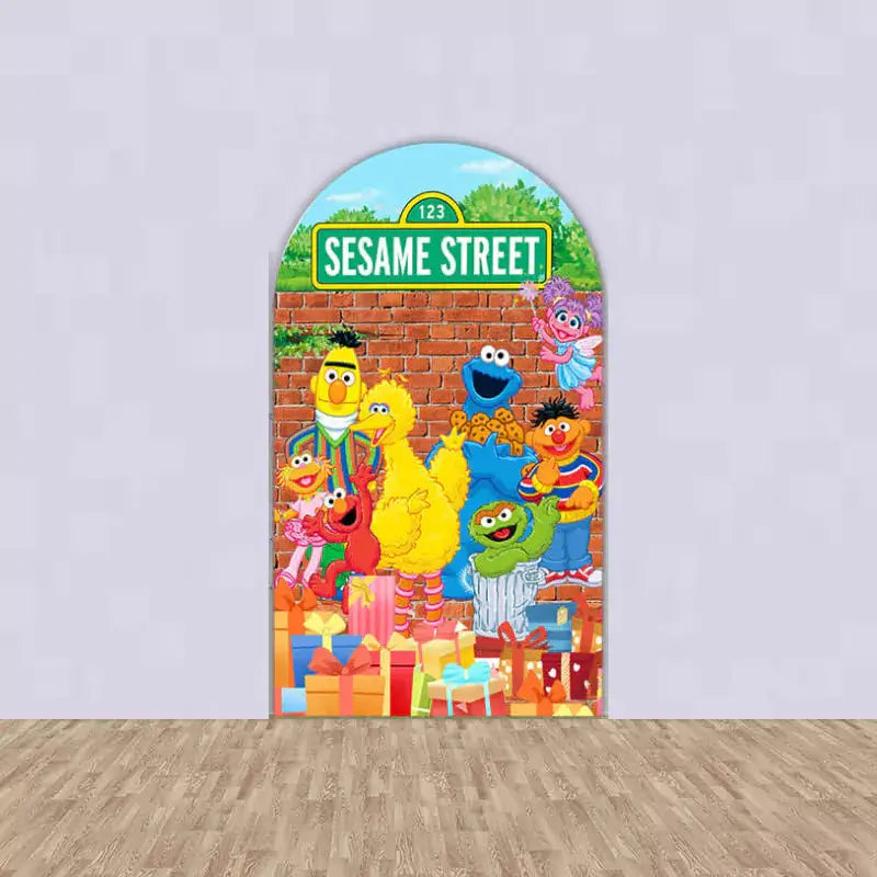 Center arch backdrop with Sesame Street sign, Big Bird, Elmo, Cookie Monster, Oscar, and birthday presents in front of a brick wall.