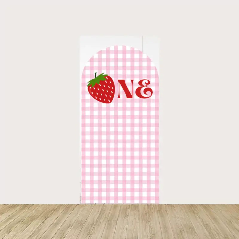 Arch panel with pink gingham pattern, a strawberry illustration, and the word “ONE” for a sweet first birthday celebration.