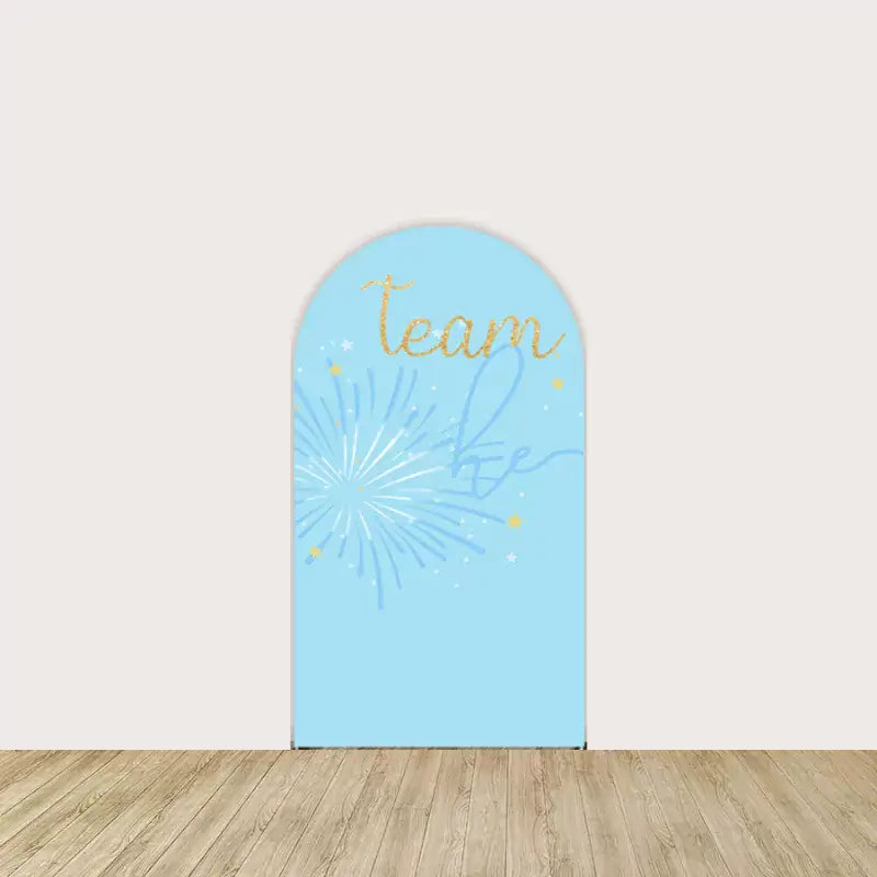 Arch panel with “Team He” text, baby blue firework illustration, and gold sparkle accents—ideal for gender reveal parties.