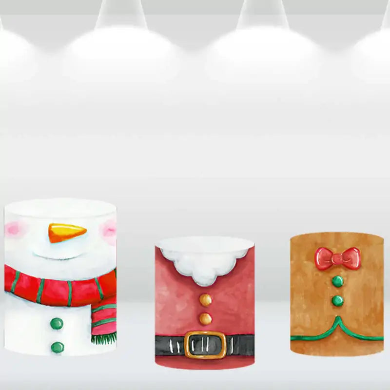 Three matching cylinder covers with snowman, Santa suit, and gingerbread cookie designs, perfect for complementing a Santa-themed holiday backdrop.