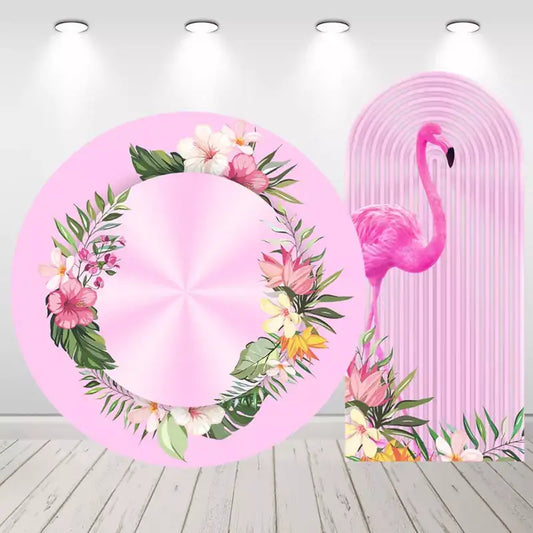 Tropical-themed backdrop set featuring a round floral design and an arched flamingo background, perfect for Hawaiian or summer-themed parties